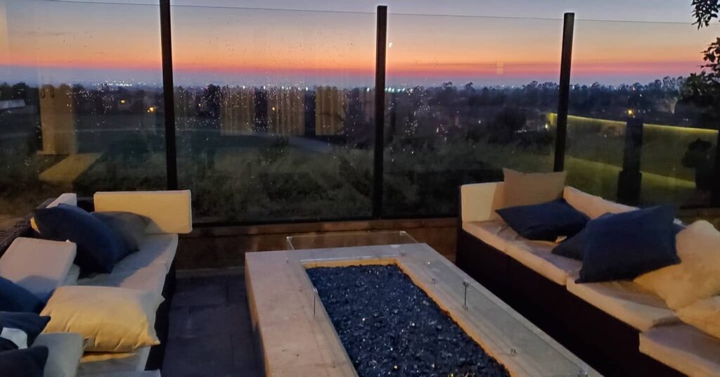Image of sunsetting over sparling clean outdoor glass railings.